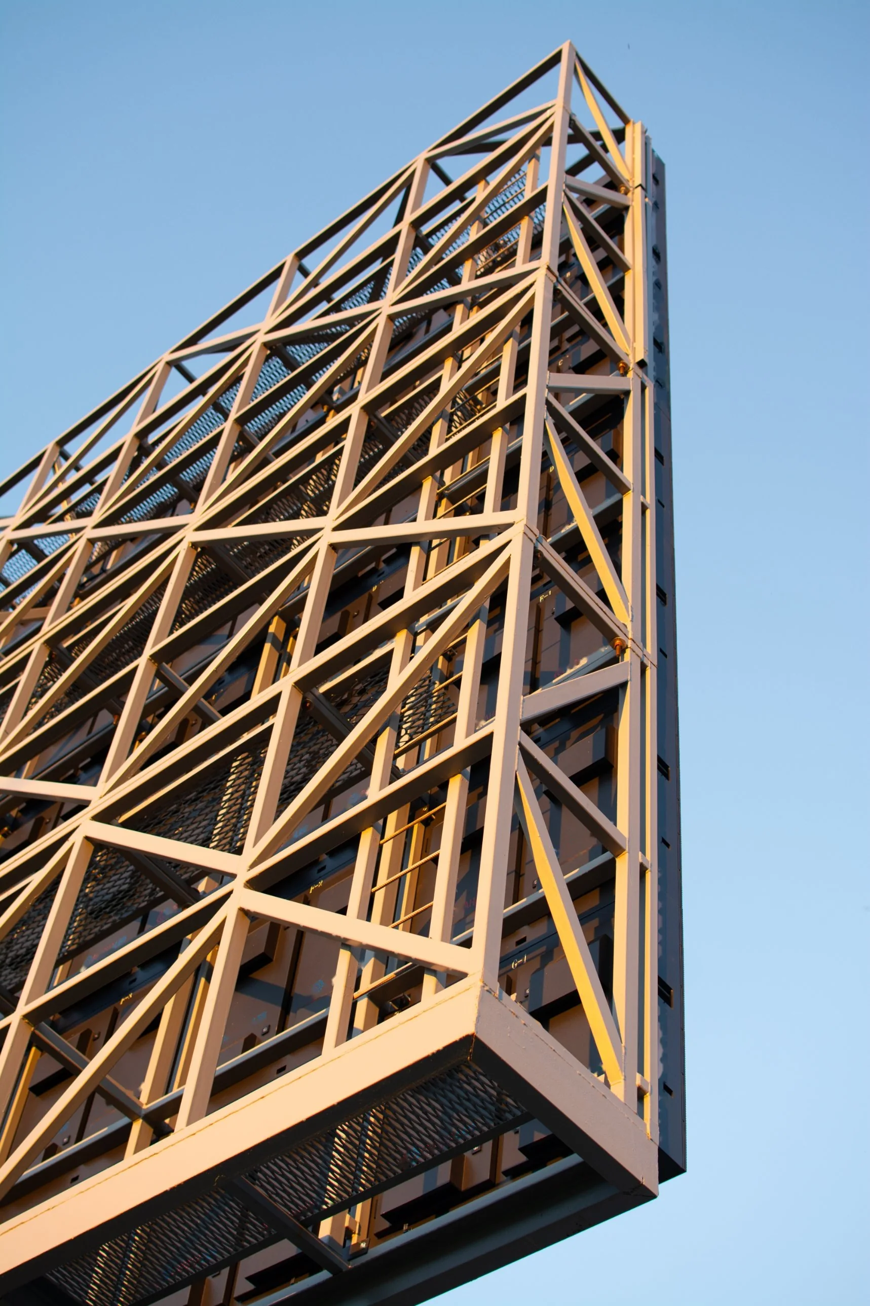 LEDCOM steel space-frame structure behind an outdoor LED screen with service platforms and ladder